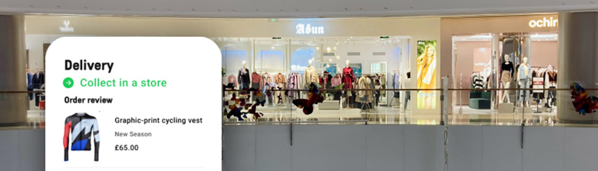 Shop front within a larger shopping centre showing a website's delivery to store message